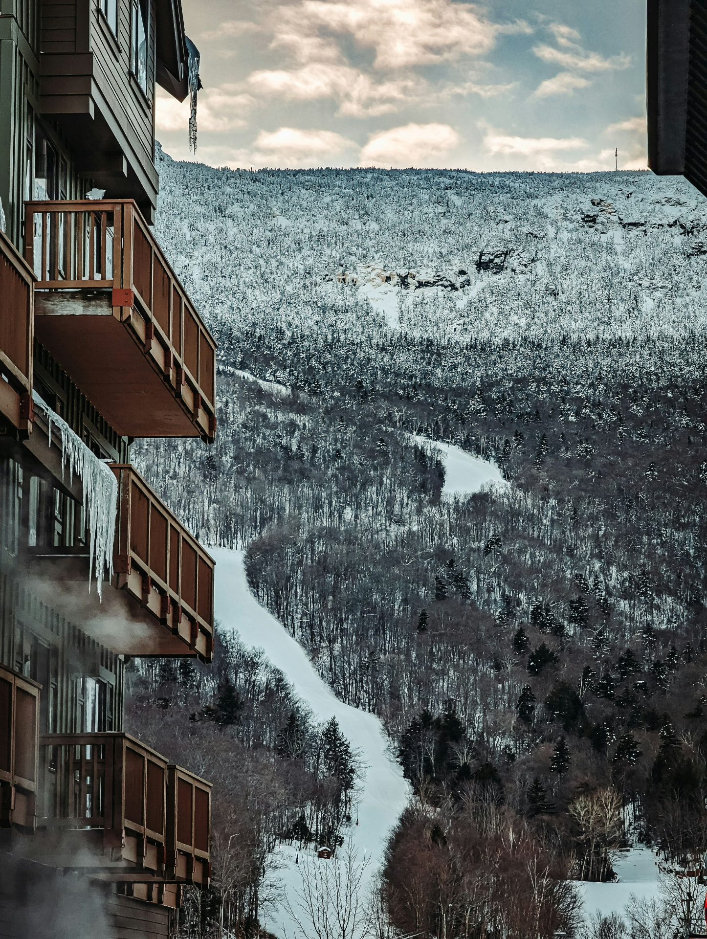 Mountain resort balconies overlooking a snow-covered ski trail